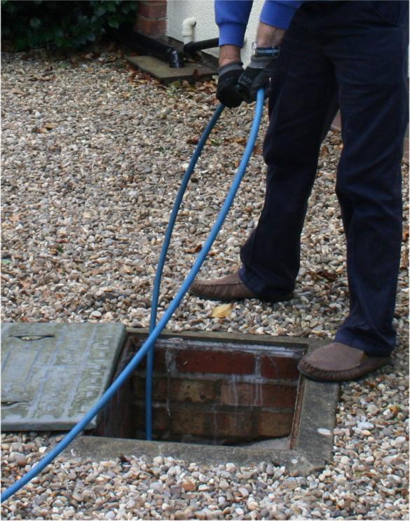 Man Cleaning a Drain